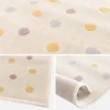 Kinderkleed met stippen, crème, blauw, geel en paars